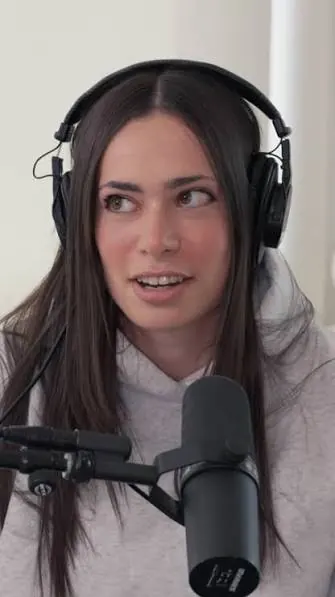 ElizabethEatsNYC speaking into a microphone in a public preview.